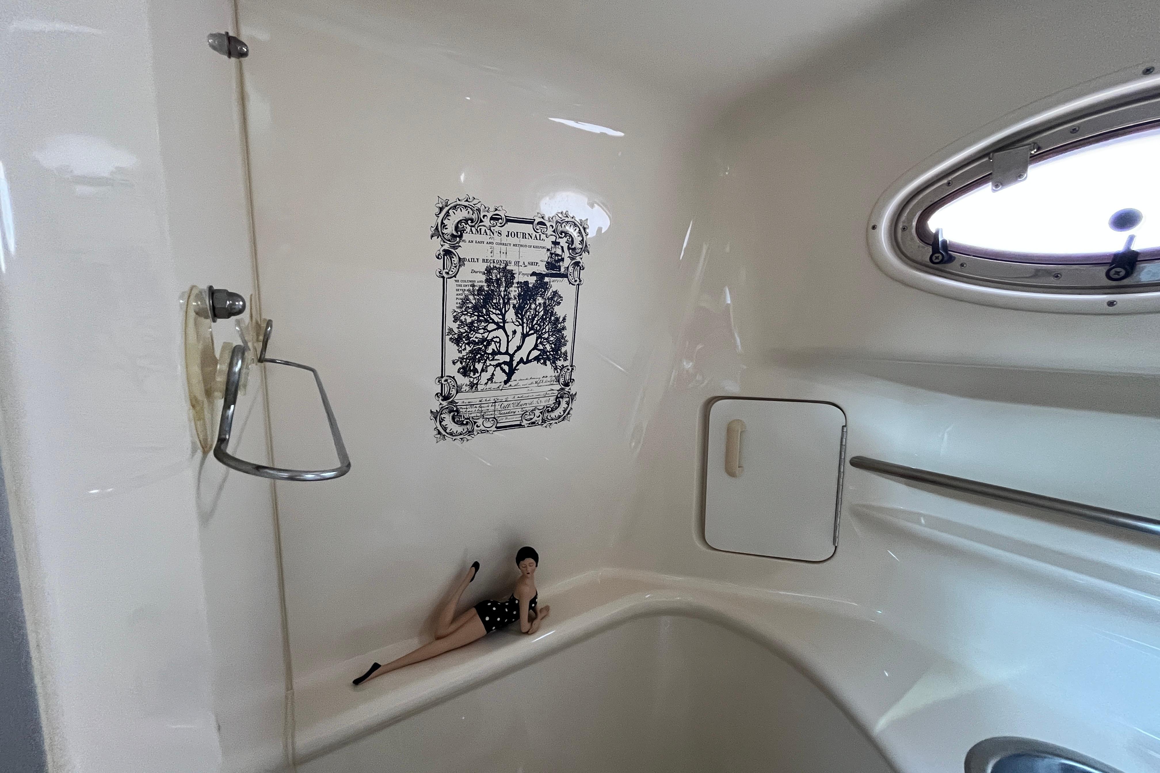 Interior of 1995 Sea Ray Sundancer 330 boat with porthole and decorative elements.