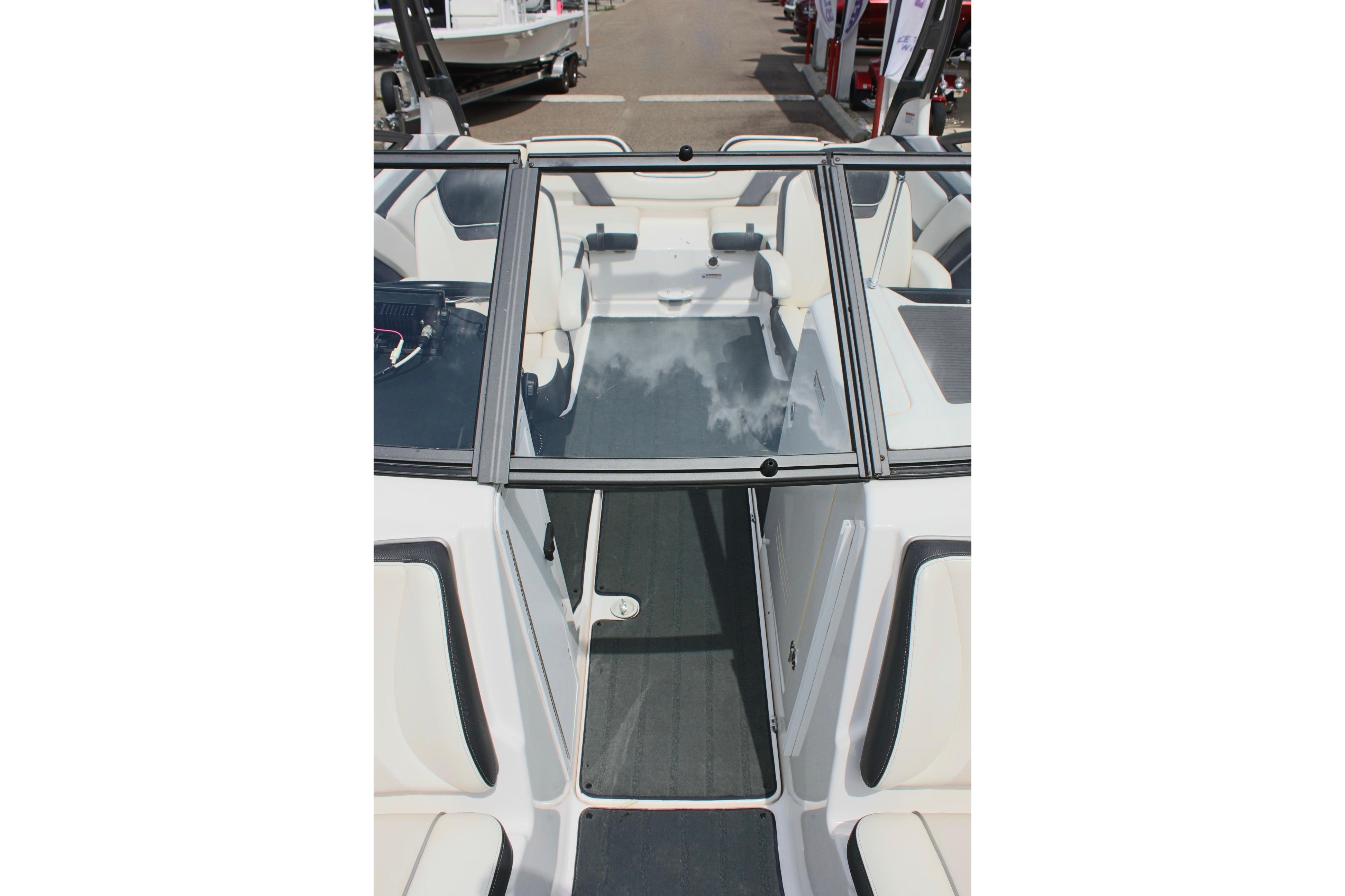 2016 Yamaha Boats 242 Limited S interior with sleek seating and glass windshield.
