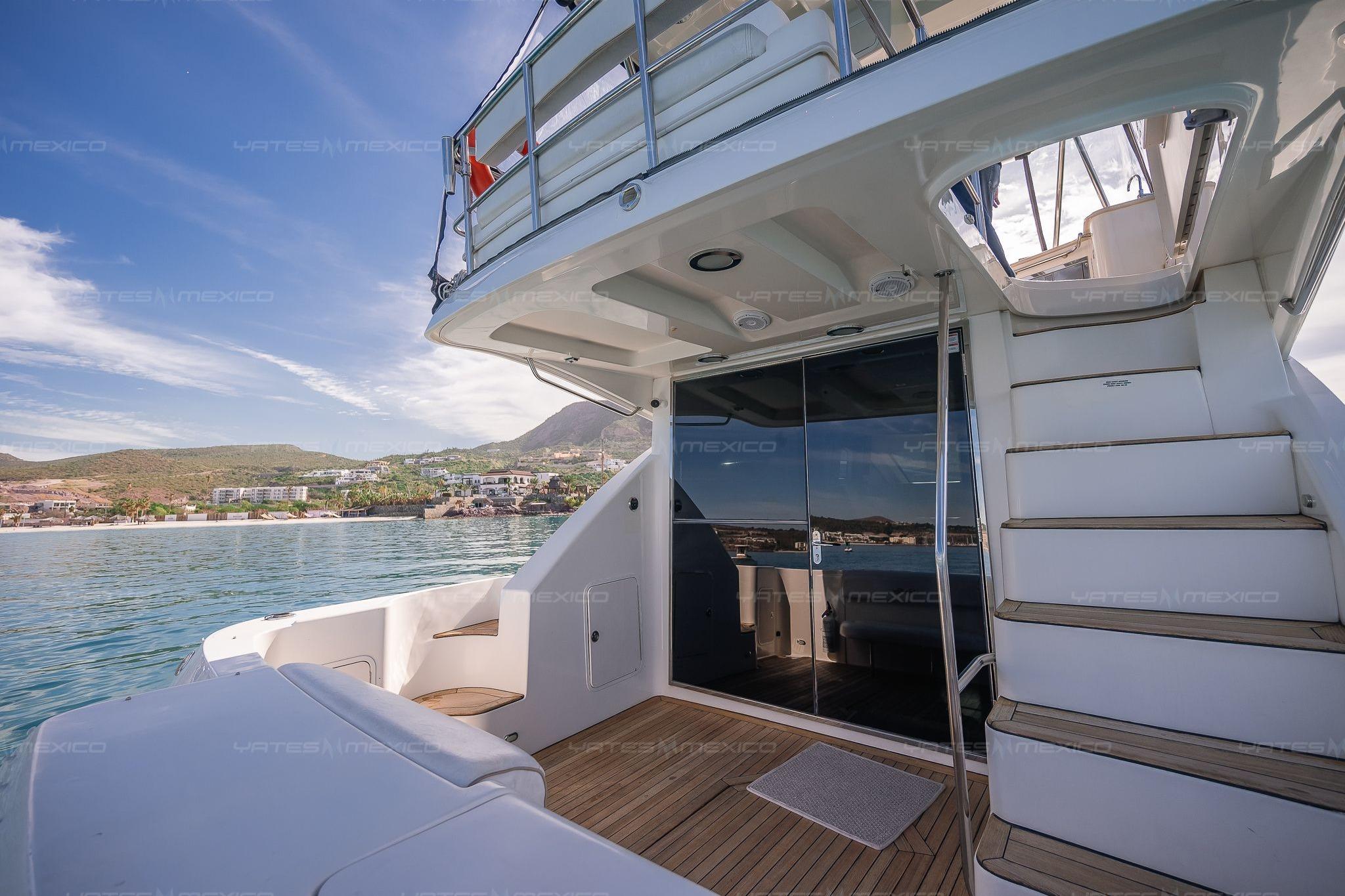 2008 Sea Ray 480 Sedan Bridge yacht with scenic coastal view and elegant deck design.