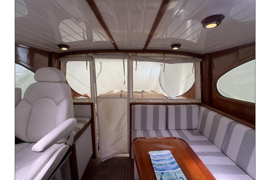 Interior of 2004 RB DERELI Daytripper 40 yacht with striped seating and wooden accents.