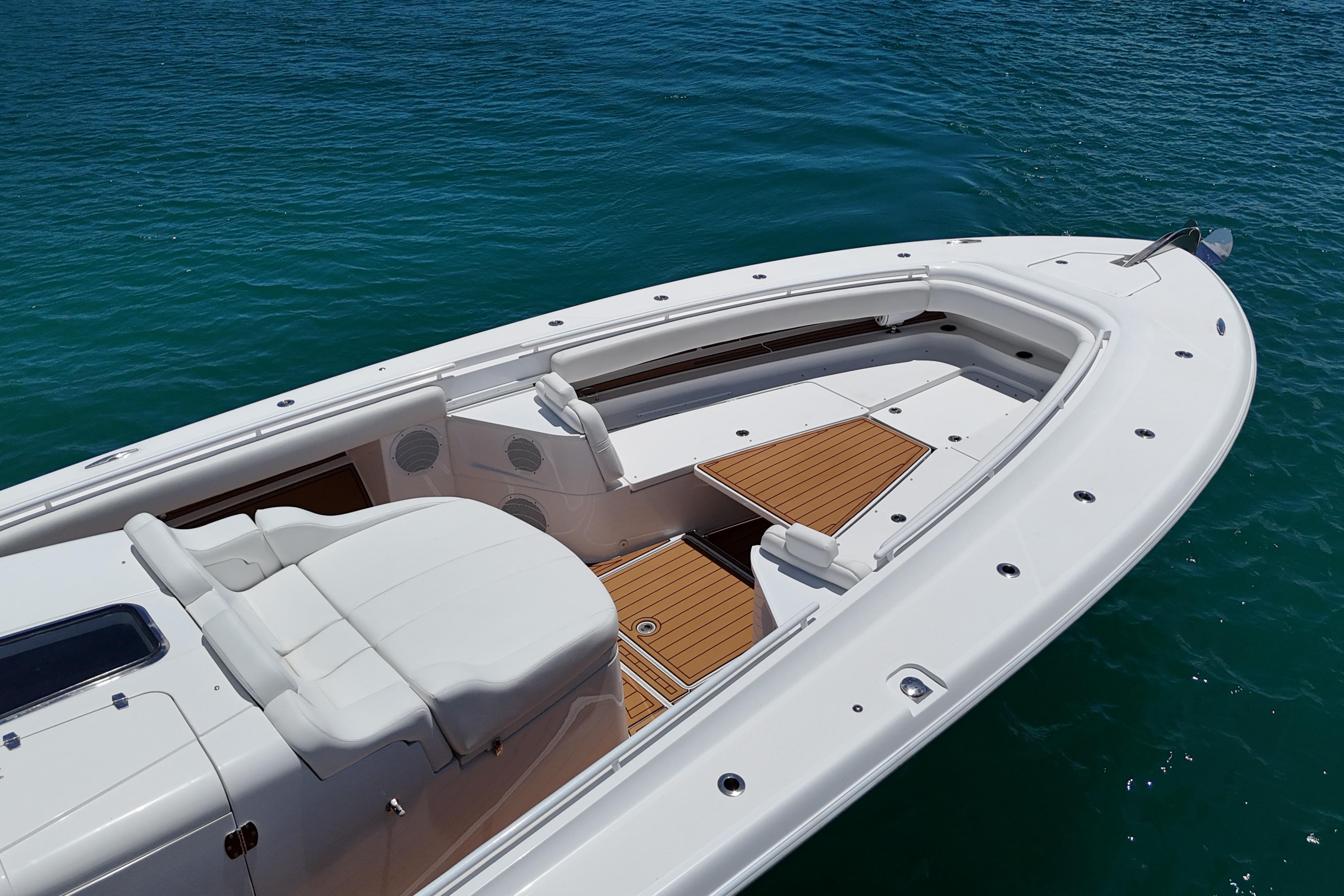 2020 HCB 53 Sueños boat with sleek white deck and wooden accents on blue water.