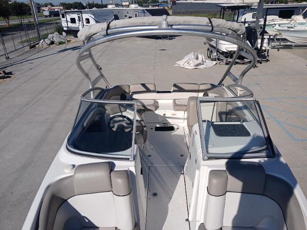 2010 Yamaha Boats 242 Limited, open deck view, parked in a marina.