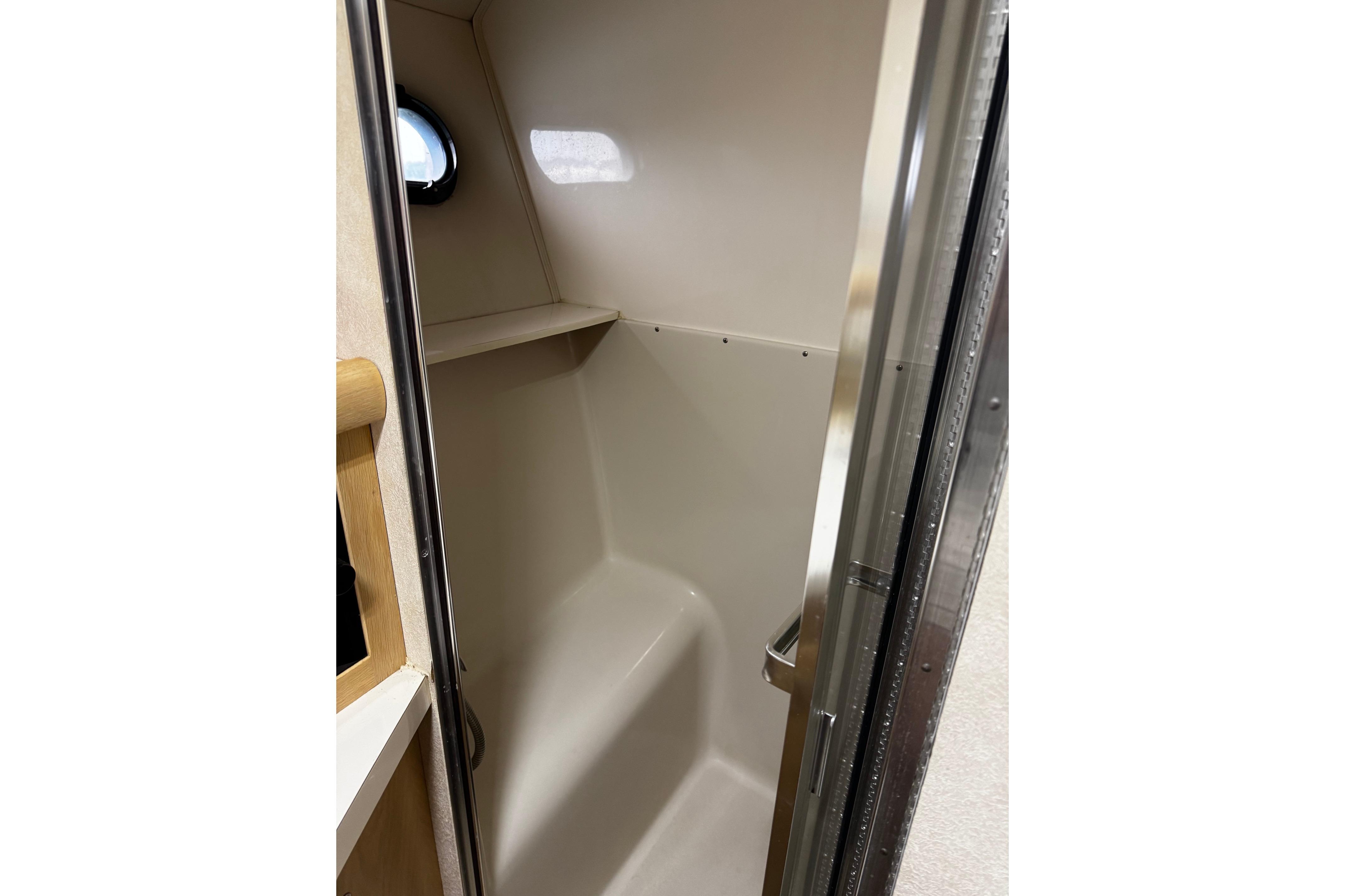 Interior of 1991 Silverton 46 Motor Yacht shower area with porthole window.