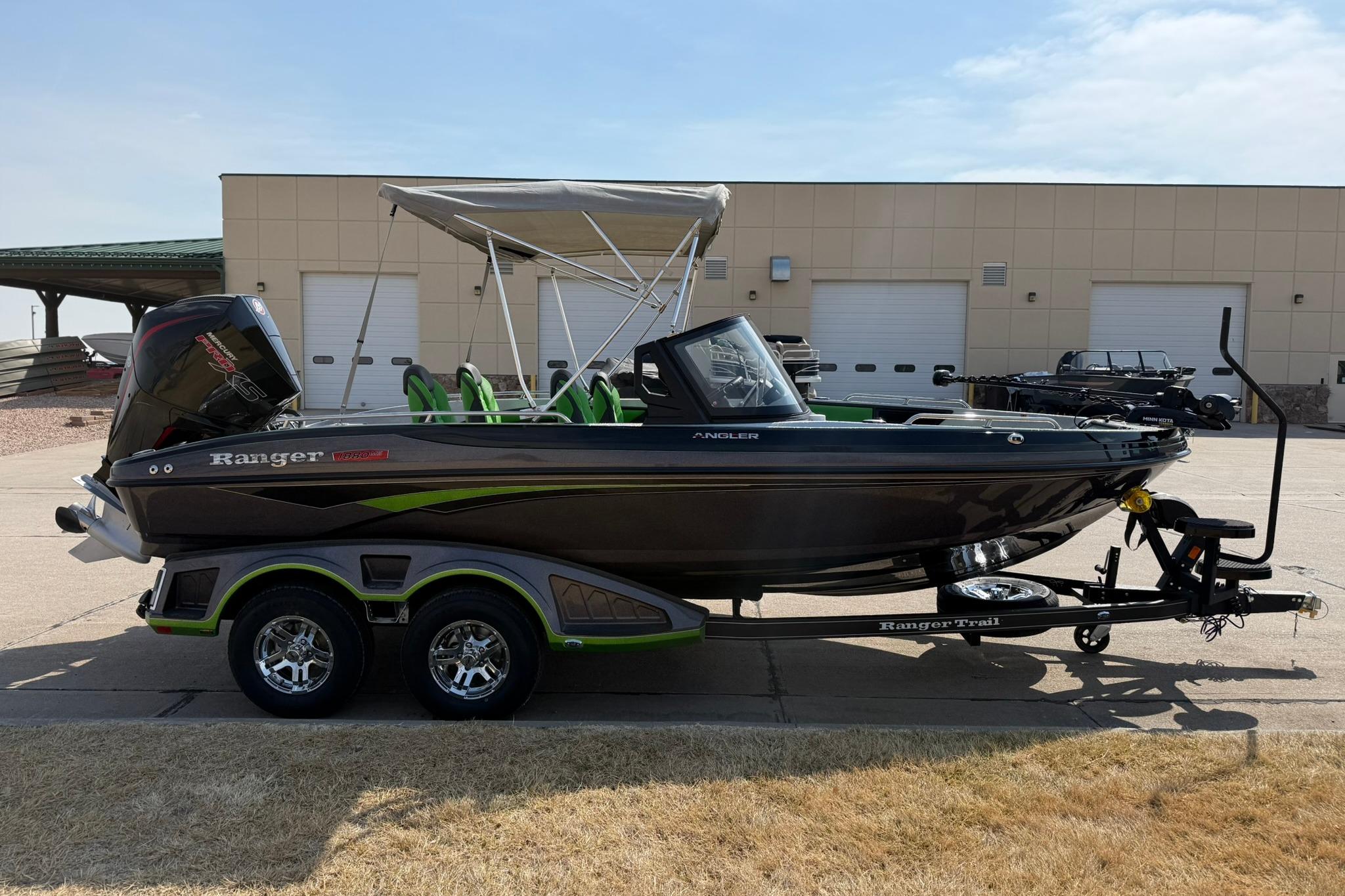 2026 Ranger 1880MS boat with trailer, parked outdoors near a building.