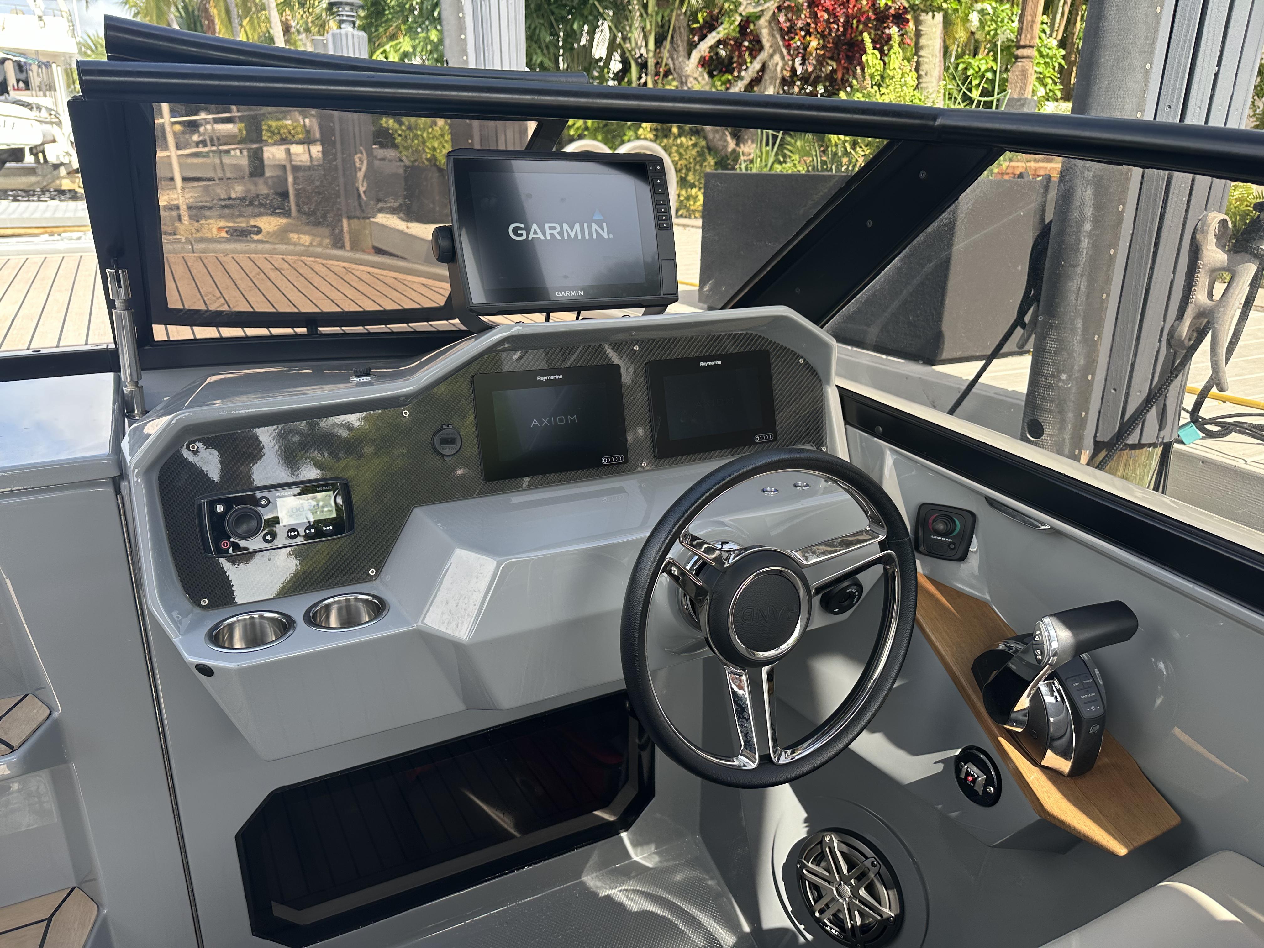 Interior of a 2021 Rand Leisure boat with Garmin navigation system and modern steering wheel.