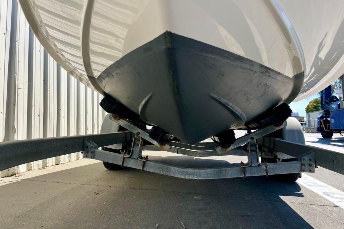 2025 Regal LX2 boat on trailer, close-up view of hull and trailer structure.