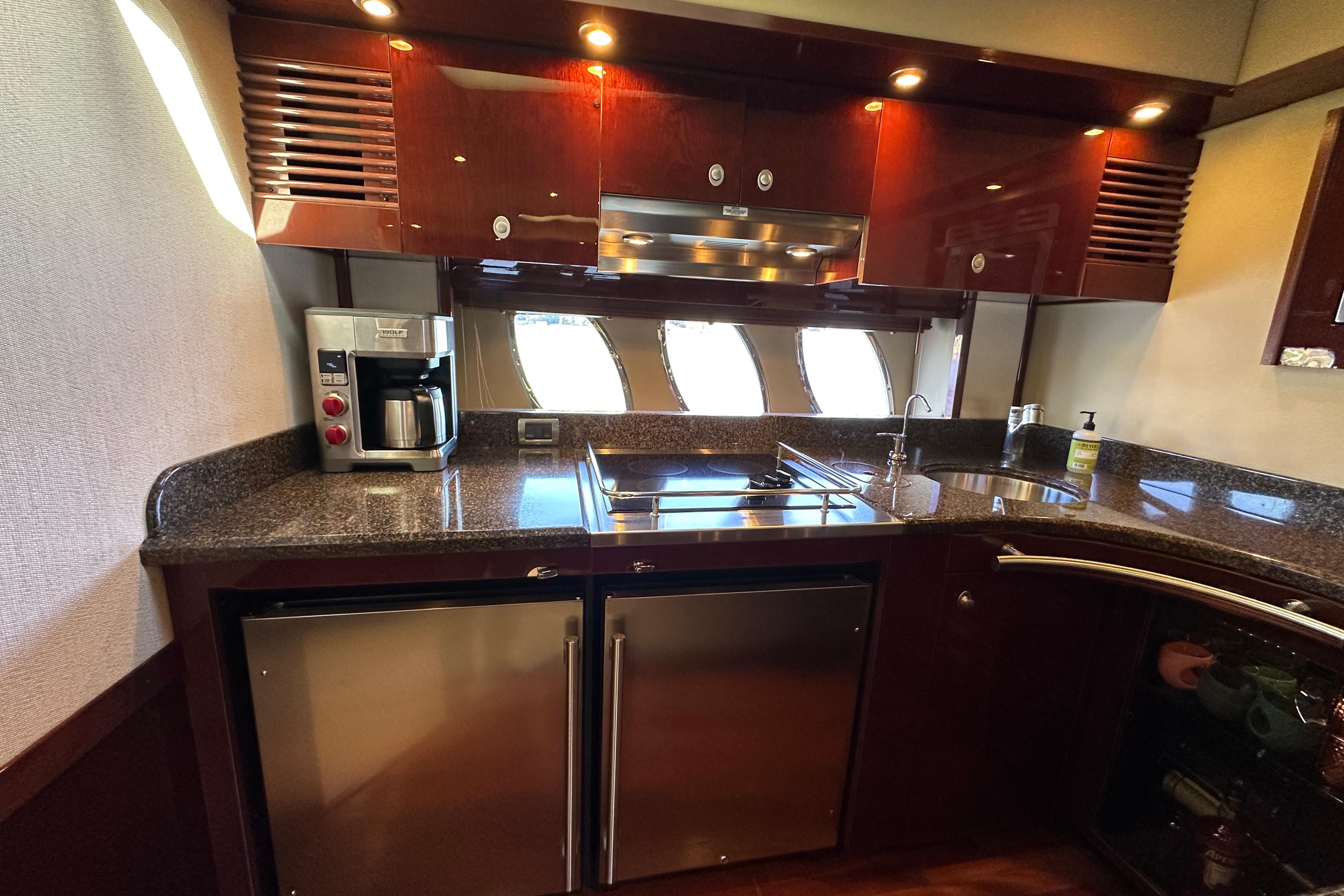 Luxurious kitchen interior of 2007 Sea Ray 60 Sundancer yacht with modern appliances.
