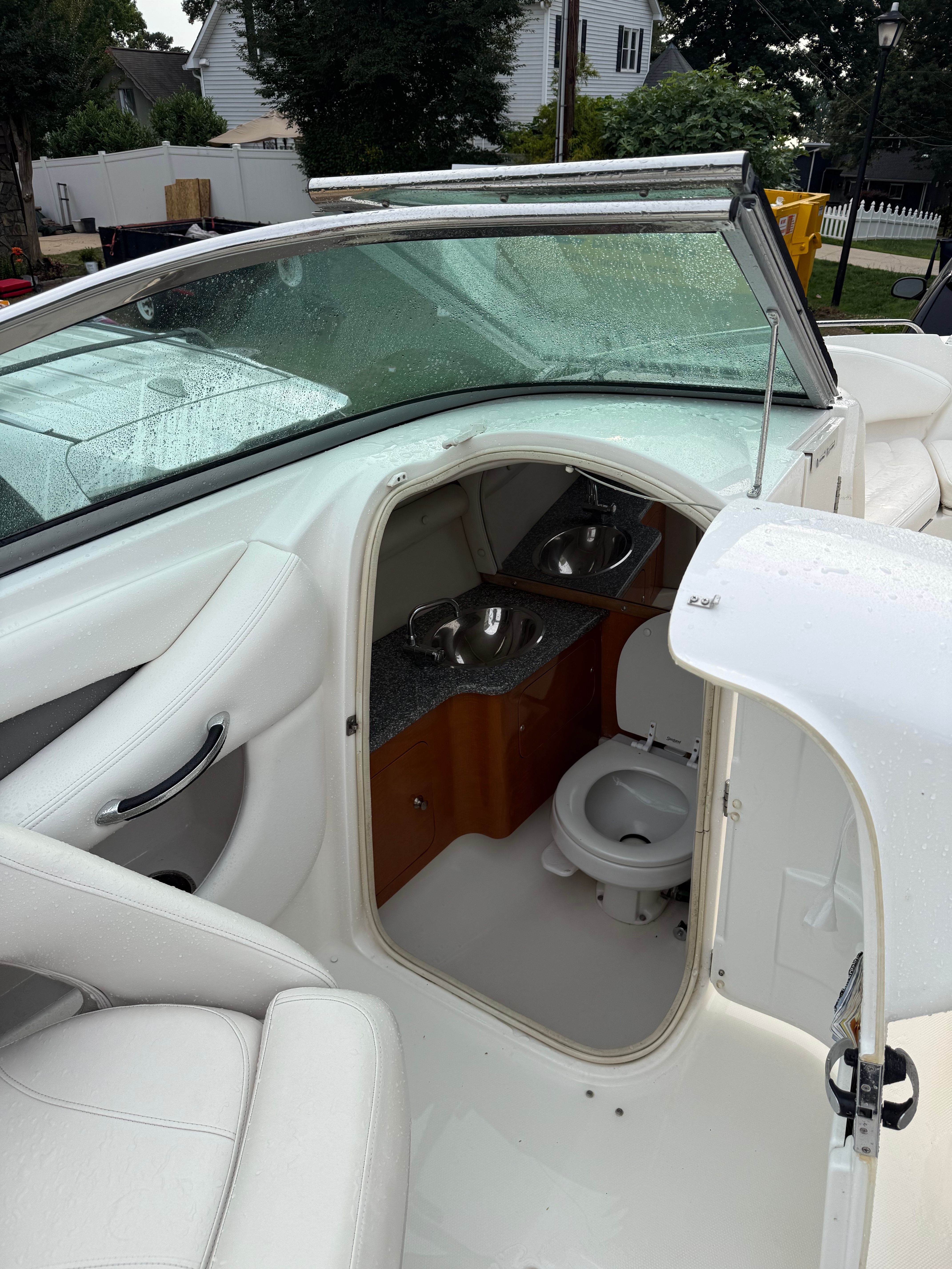 The image shows the interior of a 2007 Chaparral 256 SSX boat with a small toilet.
