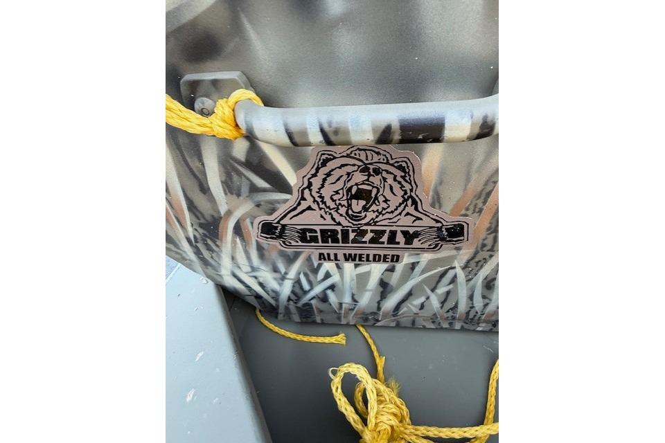 2026 Tracker Grizzly 15 Jon boat with camo design and yellow rope.