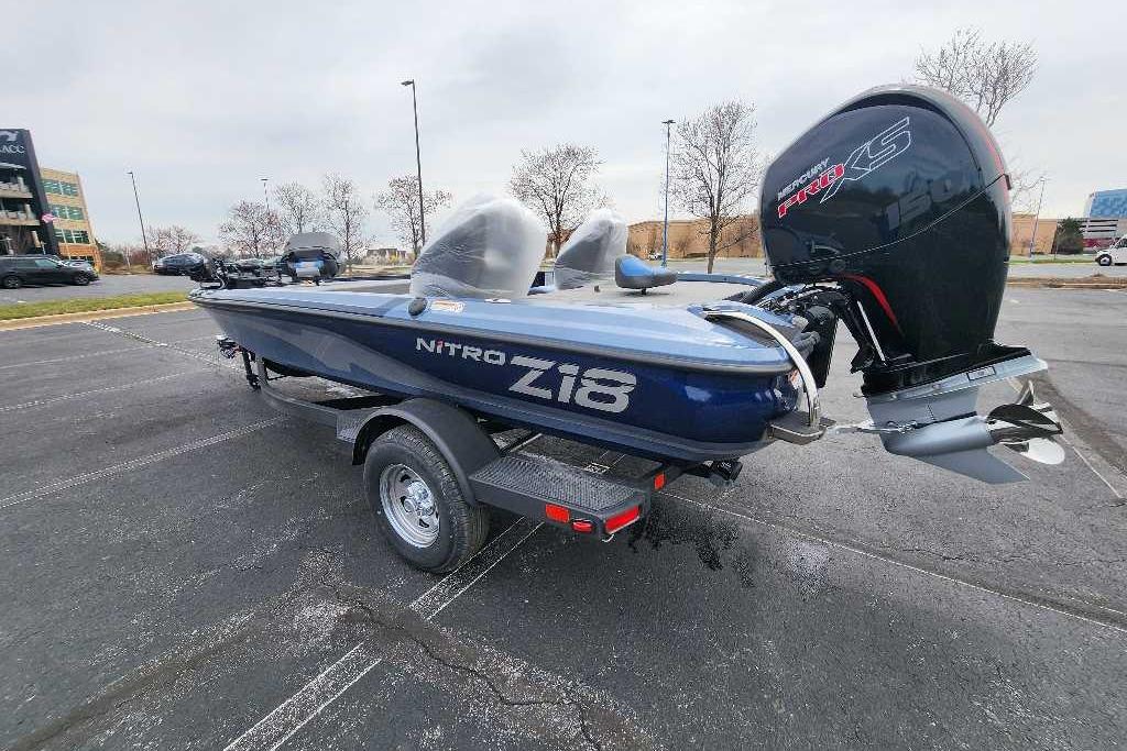 2026 Nitro Z18 Pro boat with powerful engine, parked on asphalt lot.