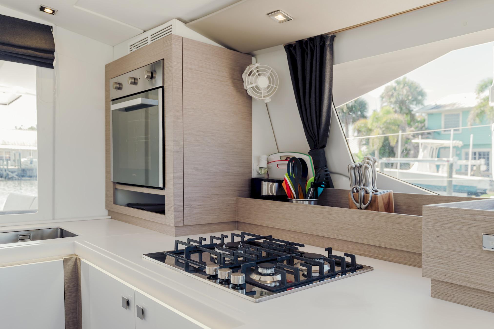 Modern kitchen interior of 2020 Fountaine Pajot Saona 47 catamaran with stove and oven.