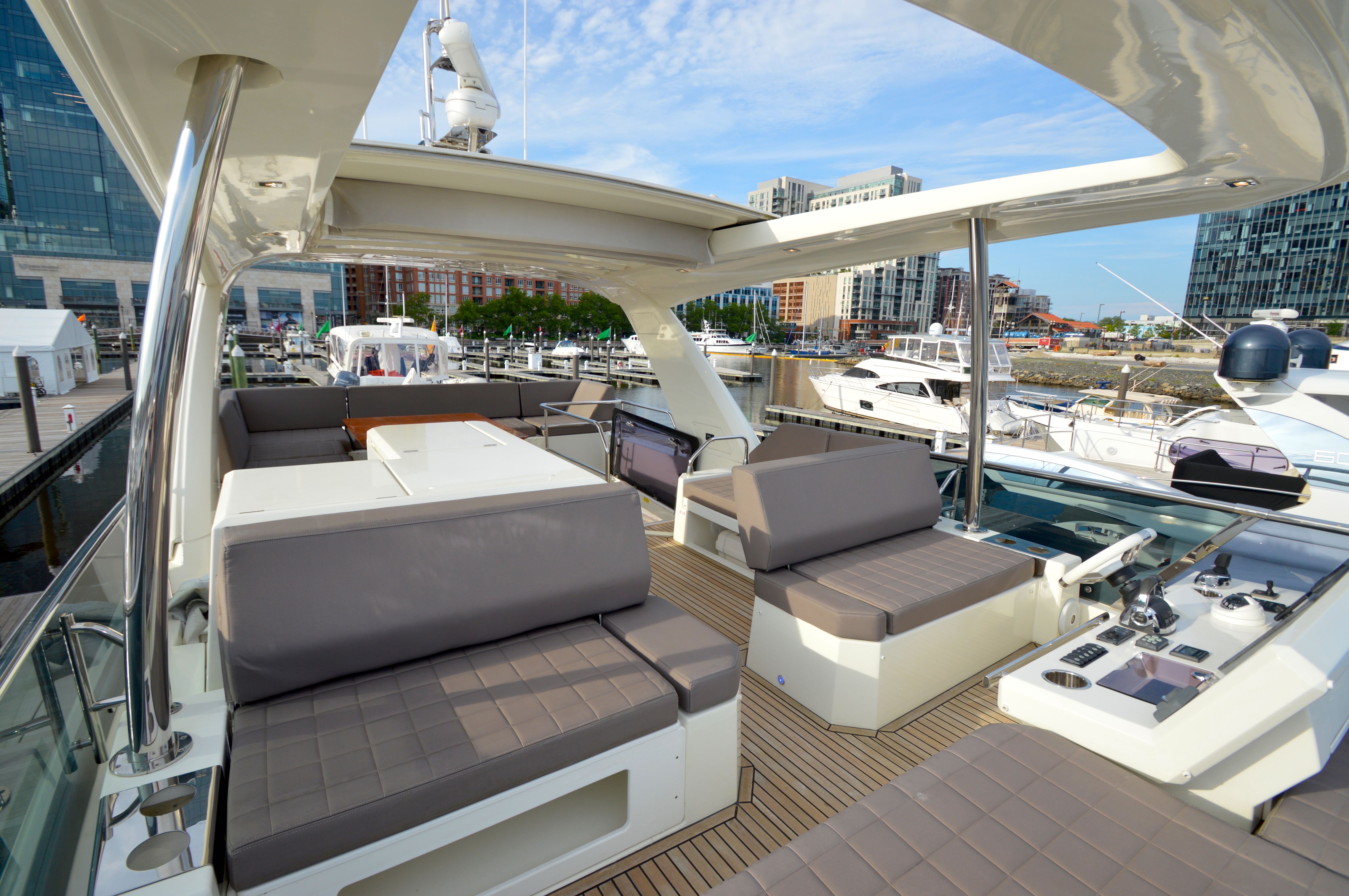 Luxury yacht Prestige 630, 2017 model, docked in modern marina.