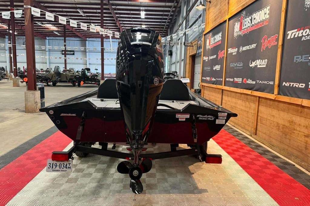 2024 Tracker Pro Team 175 boat displayed indoors, showcasing its sleek design and powerful engine.