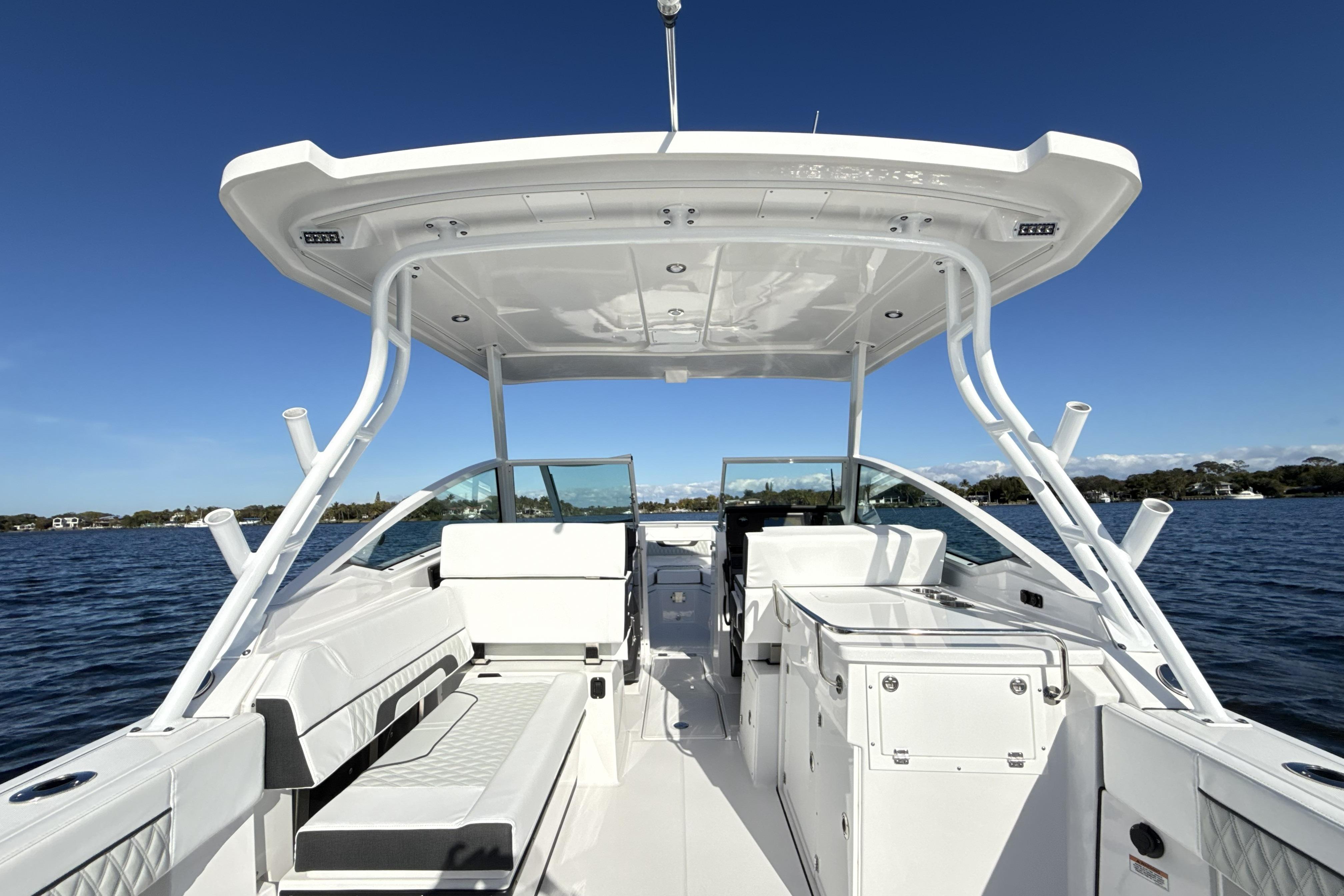 2025 Blackfin 272 DC boat interior with seating and storage, on a sunny day at sea.