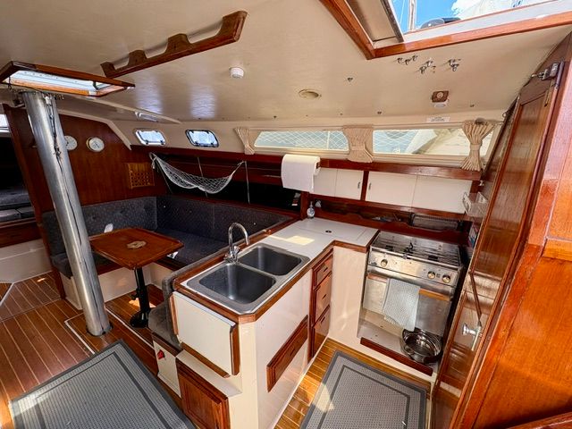 Interior of a Catalina 34 sailboat featuring a kitchen and wood finishes.