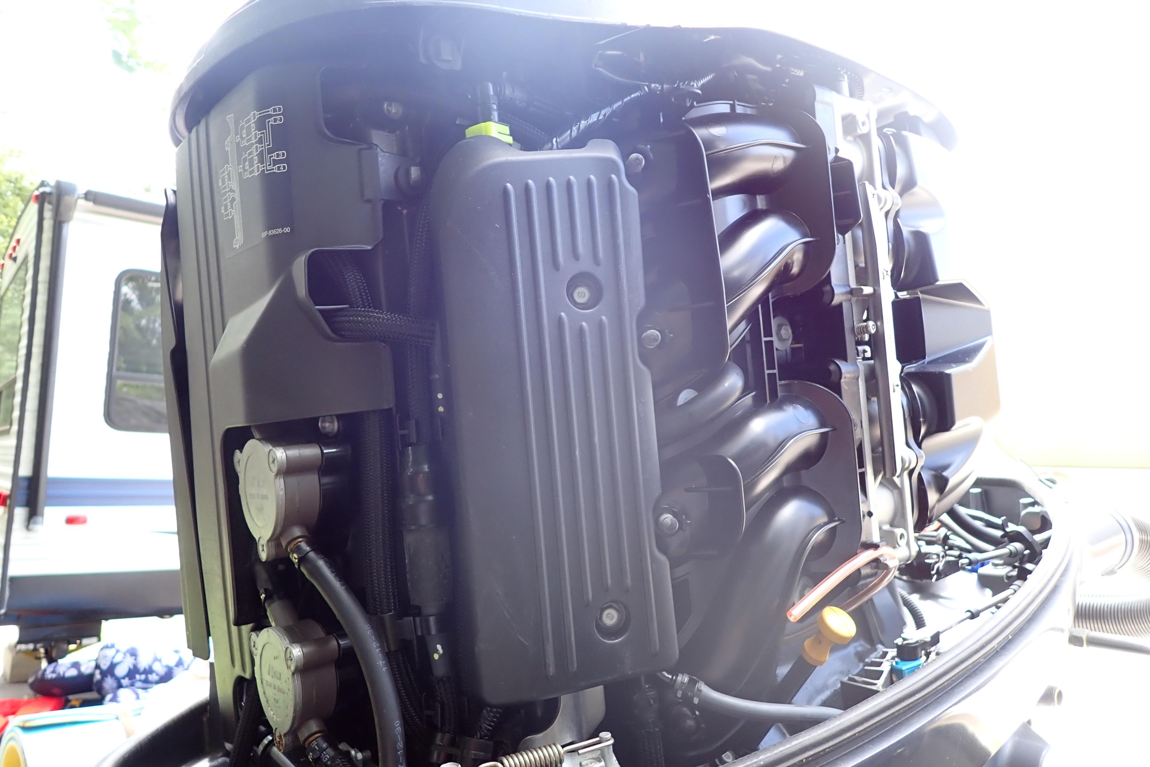 Close-up of a 2019 Key West 263 FS boat engine, showcasing intricate mechanical details.
