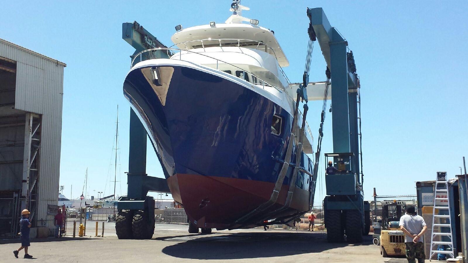Allseas Expedition yacht 2018 in shipyard, lifted by crane for maintenance.