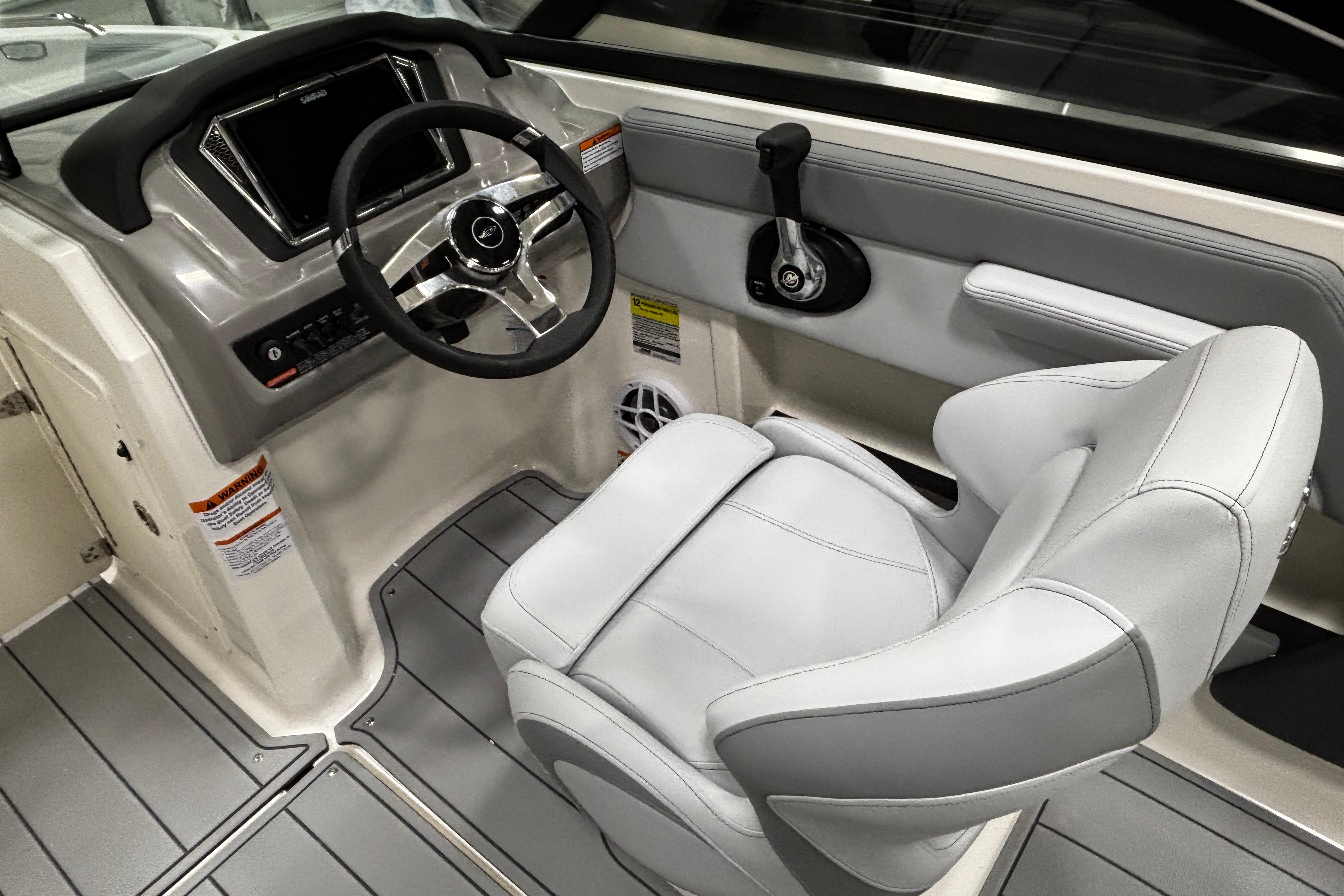 2026 Chaparral 21 SSi boat interior with steering wheel and captain's seat.