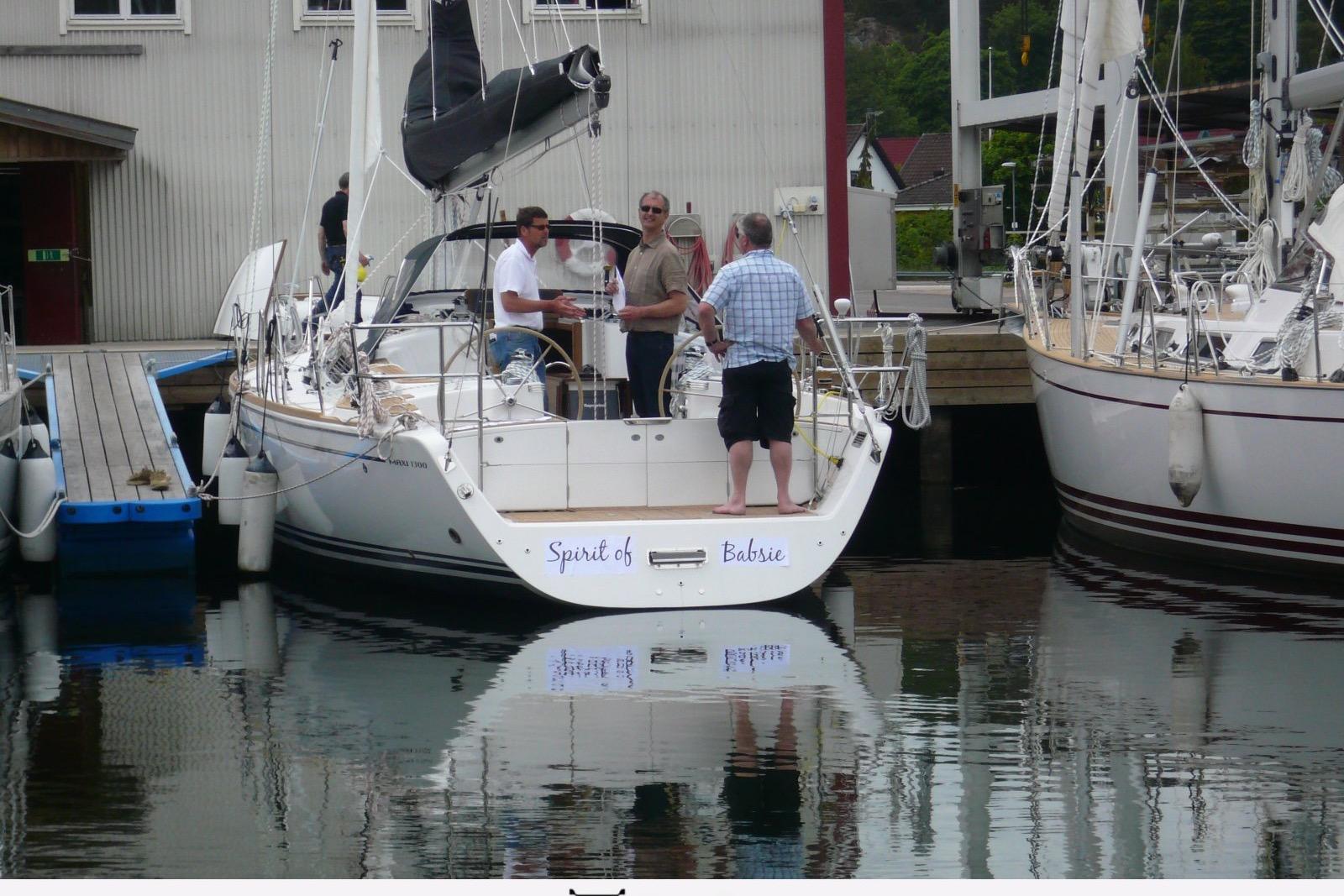 Sailboat "Spirit of Babsie" docked, Maxi 1300 model, 2010, with people onboard.