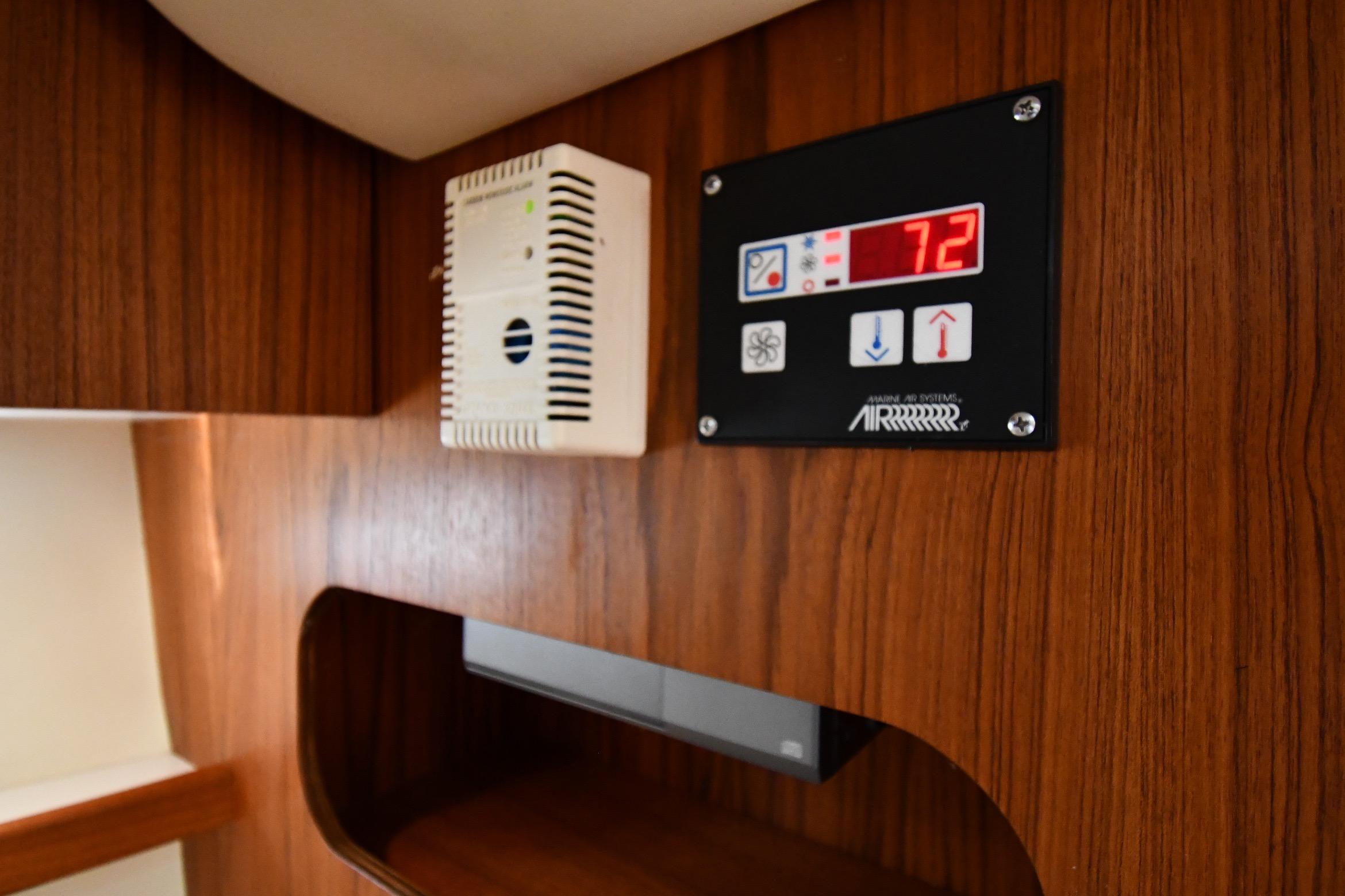 Control panel and vent on 1998 Tiara Yachts 3100 Open's wooden interior.