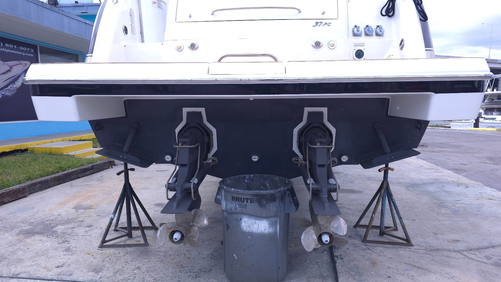 Rear view of a 2016 Formula 37 Performance Cruiser with two outboard motors on stands.