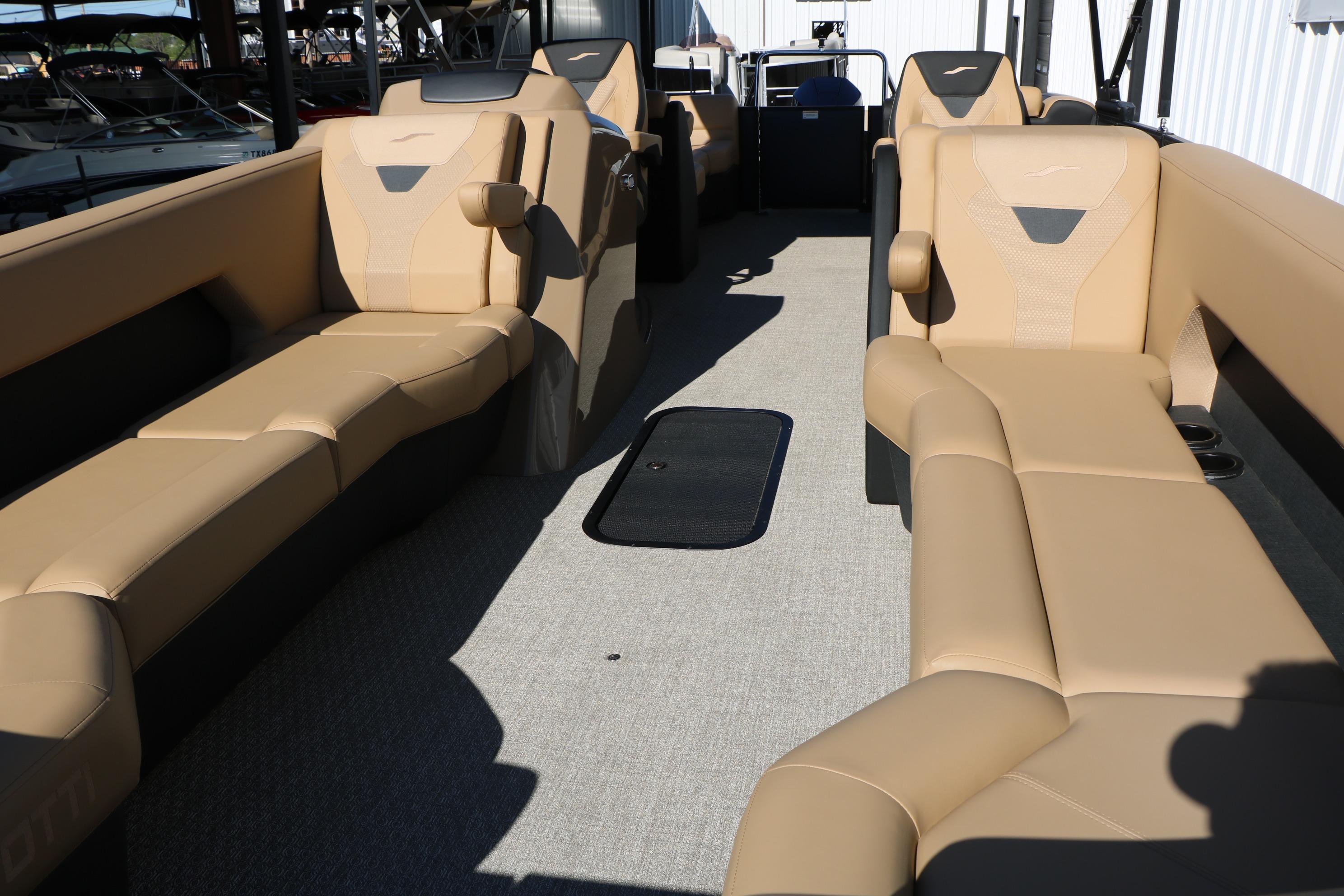 Luxurious interior of 2026 Evotti 525 QL Tri-Toon boat with beige seating.