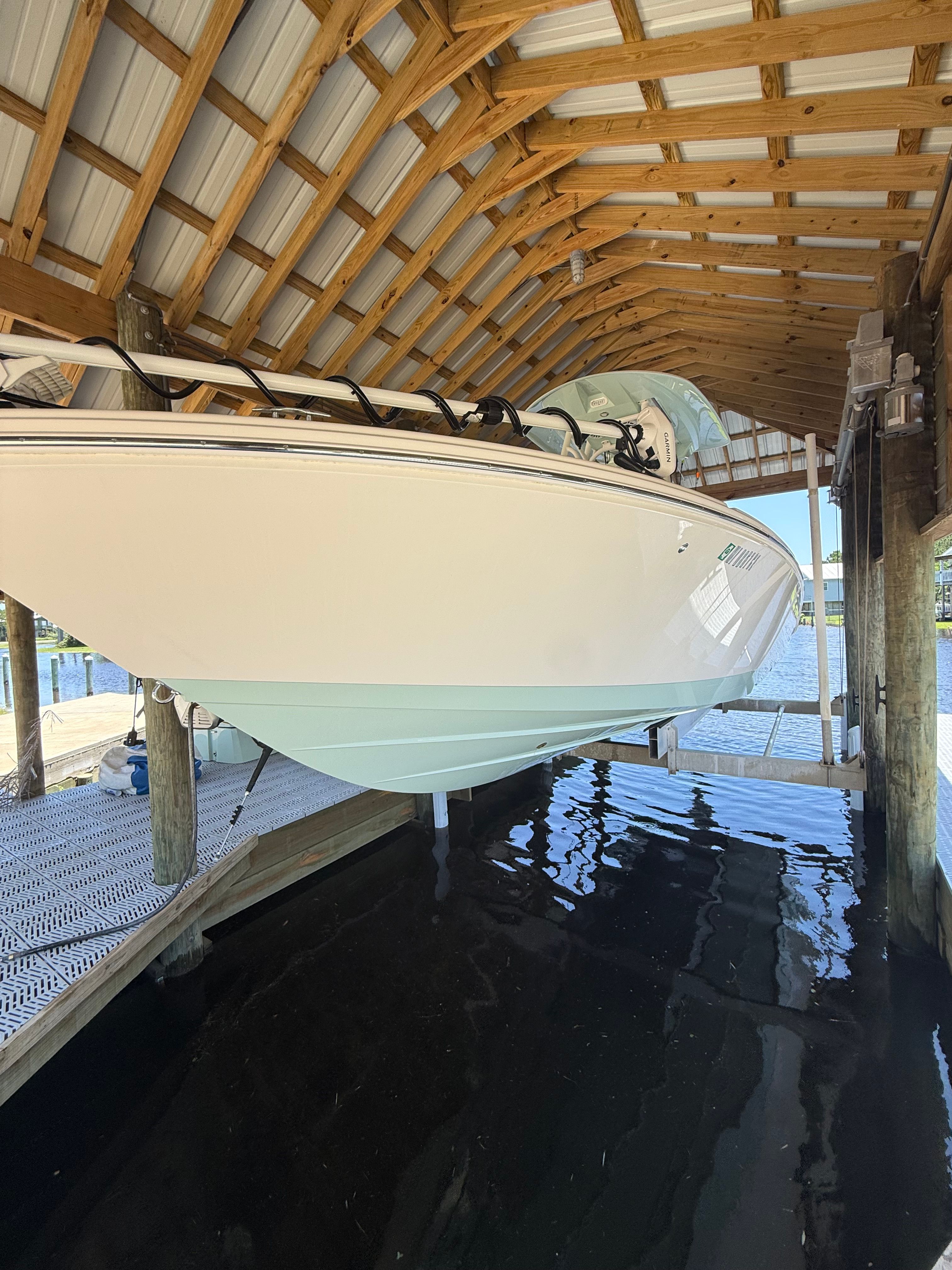 Pathfinder 2700 Open 2024 under a boathouse roof.