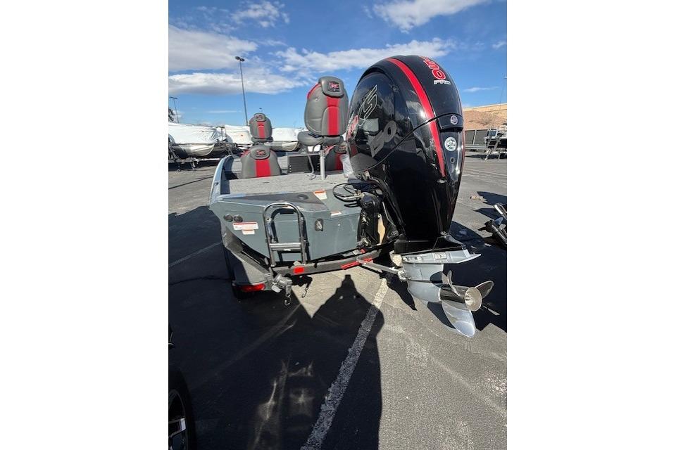 2026 Ranger RT198P boat with powerful outboard motor, parked outdoors under blue sky.
