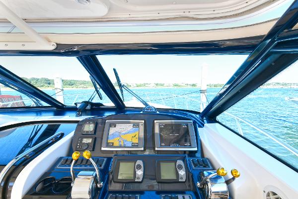 2008 Tiara Yachts 4200 Open helm with navigation screens and ocean view.