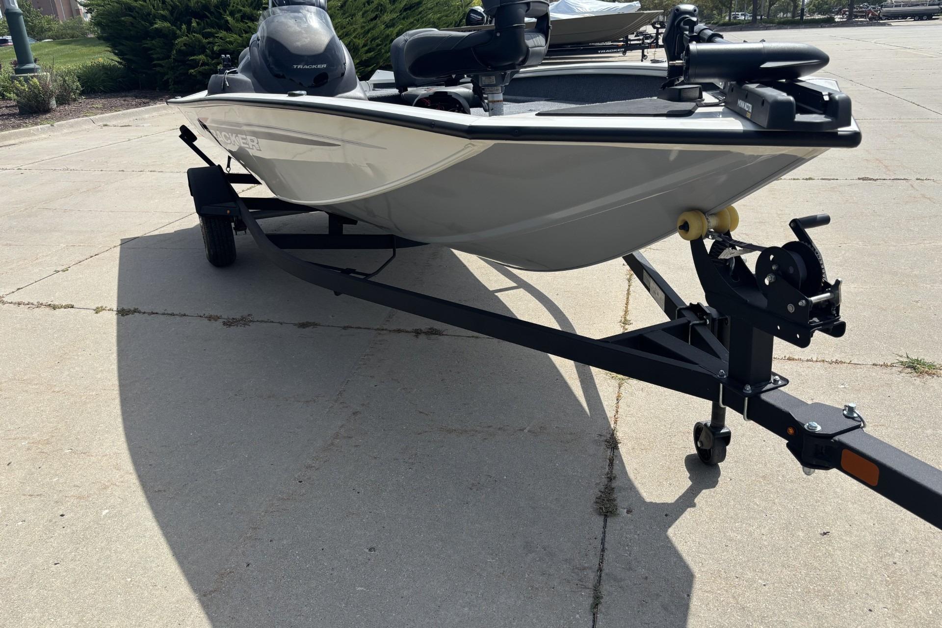 2024 Tracker Pro Team 175 TF boat on trailer, parked on concrete surface.