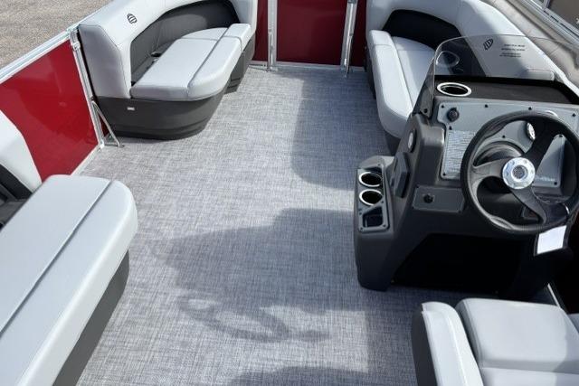 2026 Sun Tracker Party Barge 16 DLX interior with gray seating and steering console.