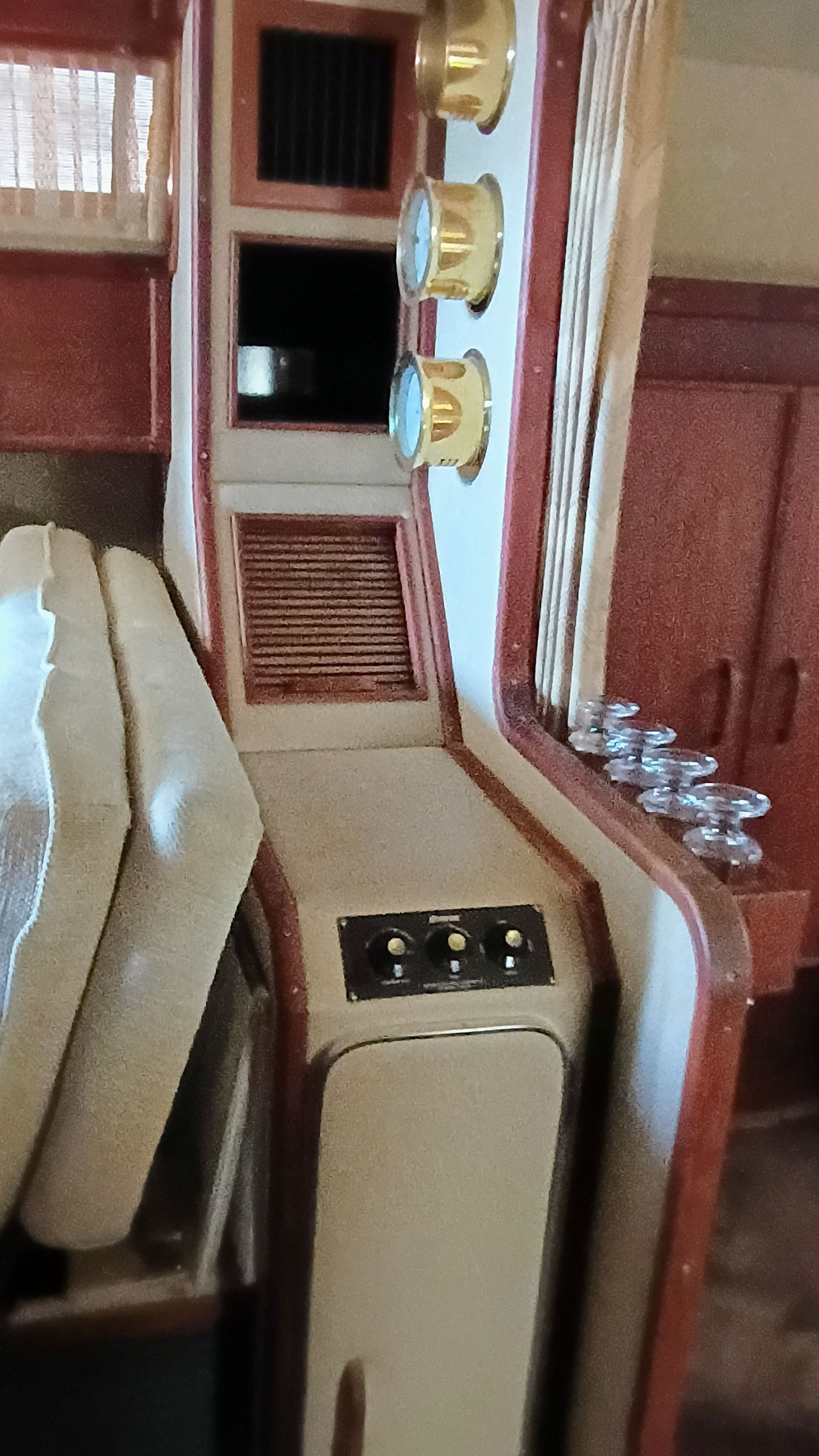 Interior of a 1986 Sea Ray Sundancer with wooden cabinetry and gauges.
