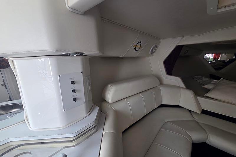 Interior of 2004 Fountain 38 Lightning boat with white leather seating and control panel.