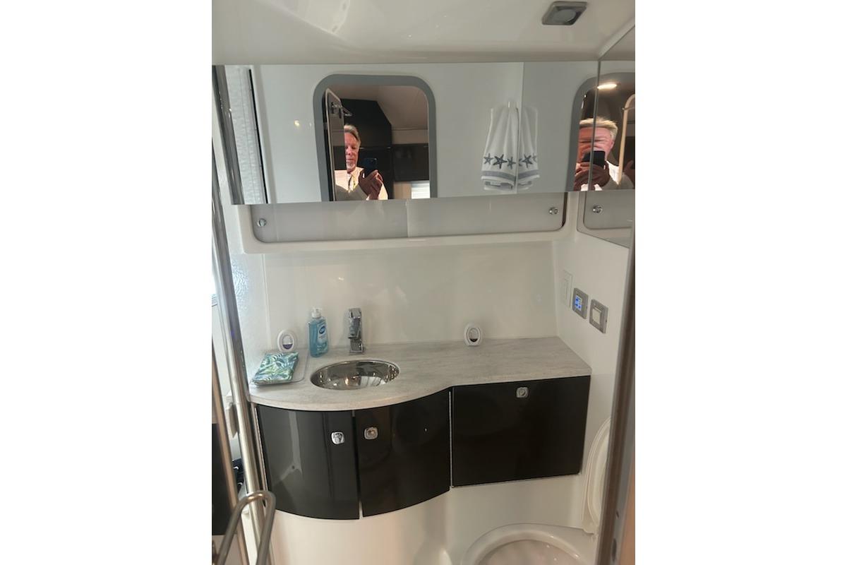 2018 Formula 40 Performance Cruiser bathroom with modern sink and mirrored cabinet.