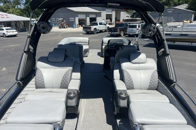 2024 Manitou 25 LX SRW pontoon boat interior with luxurious seating and modern design.