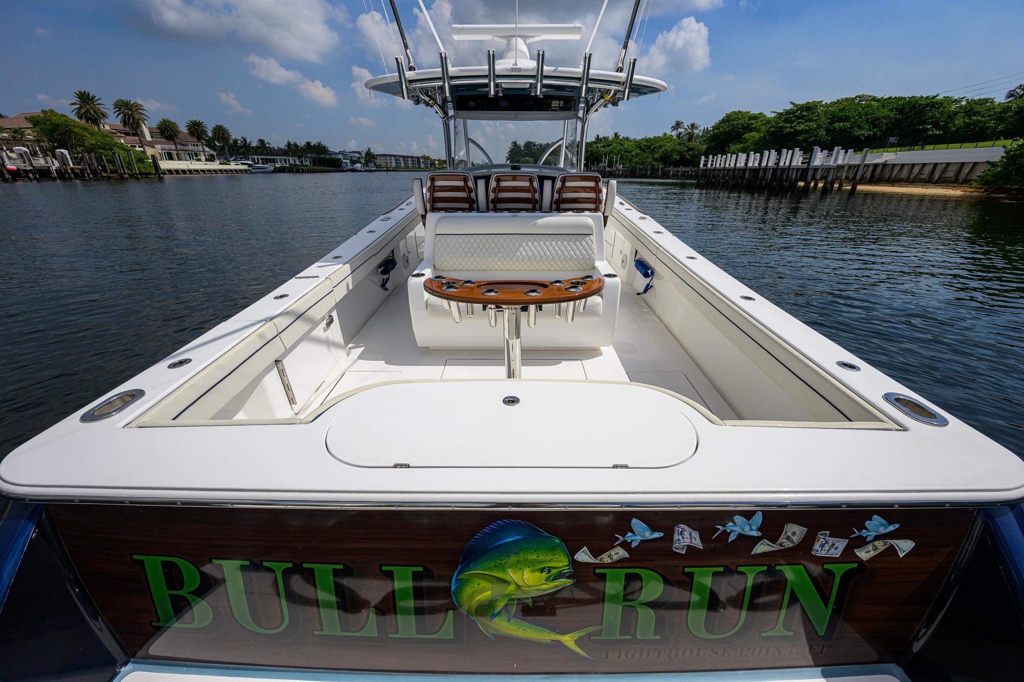 2020 Valhalla Boatworks V-41 on water, featuring spacious deck and custom graphics.