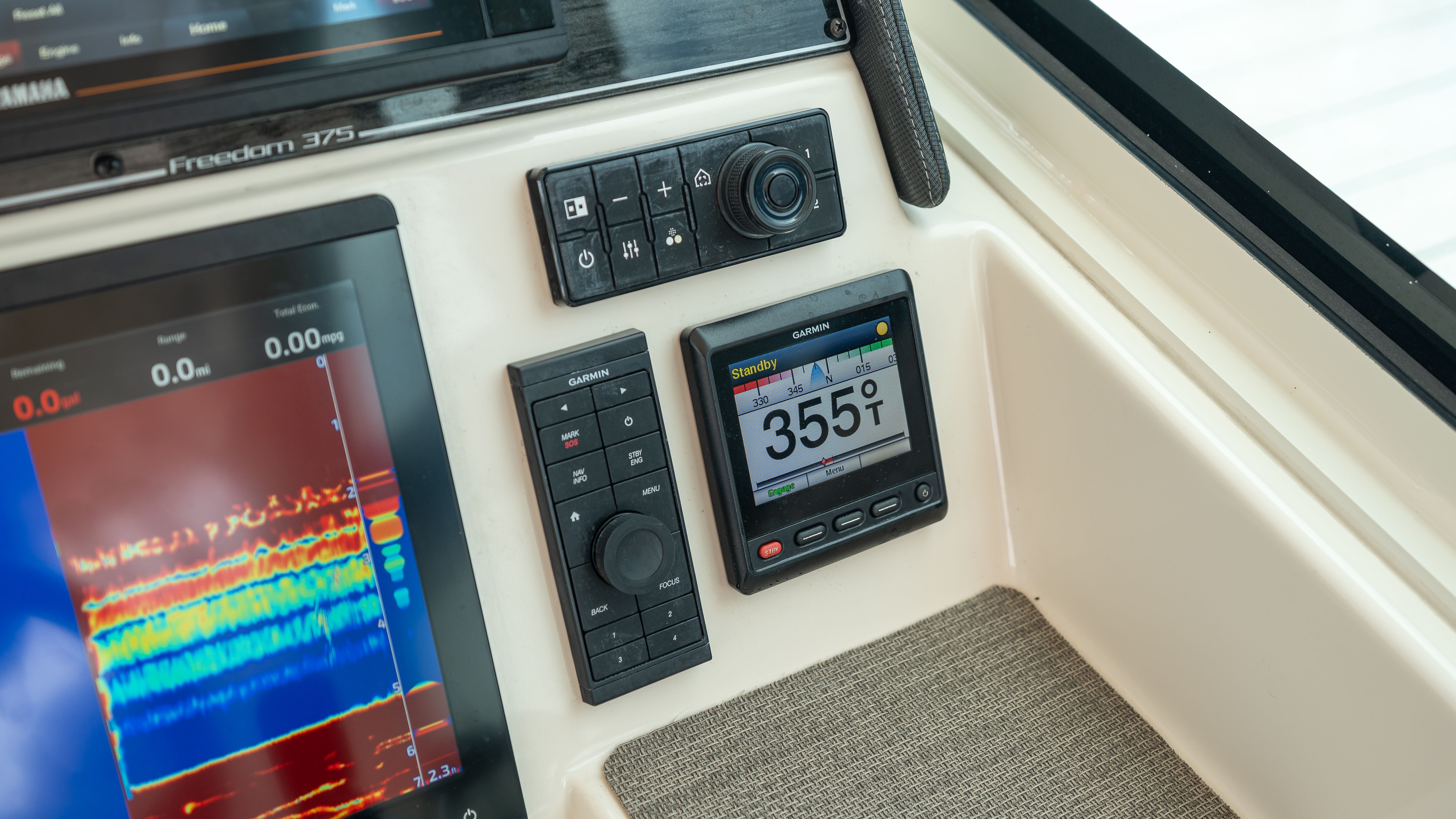 The image shows the dashboard of a Grady-White 375 Freedom boat with navigation equipment.