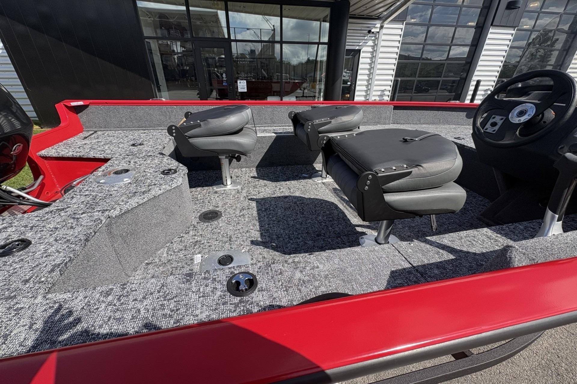 2026 Tracker Pro Guide V-16 SC boat interior with gray carpet and black seats.