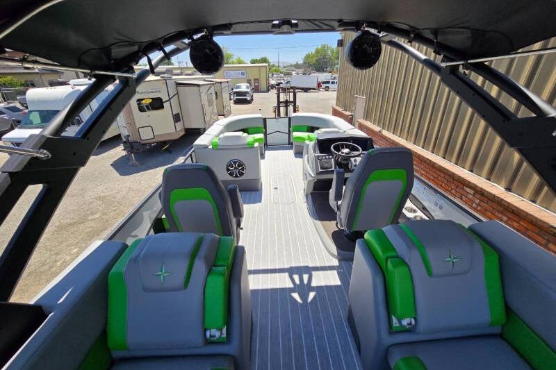 2026 Berkshire STS Arch Performance Series boat interior with green and gray seating.