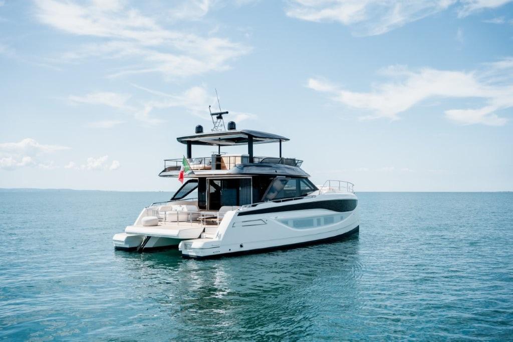 Luxury Prestige M7 yacht, 2025 model, cruising on calm blue waters under a clear sky.