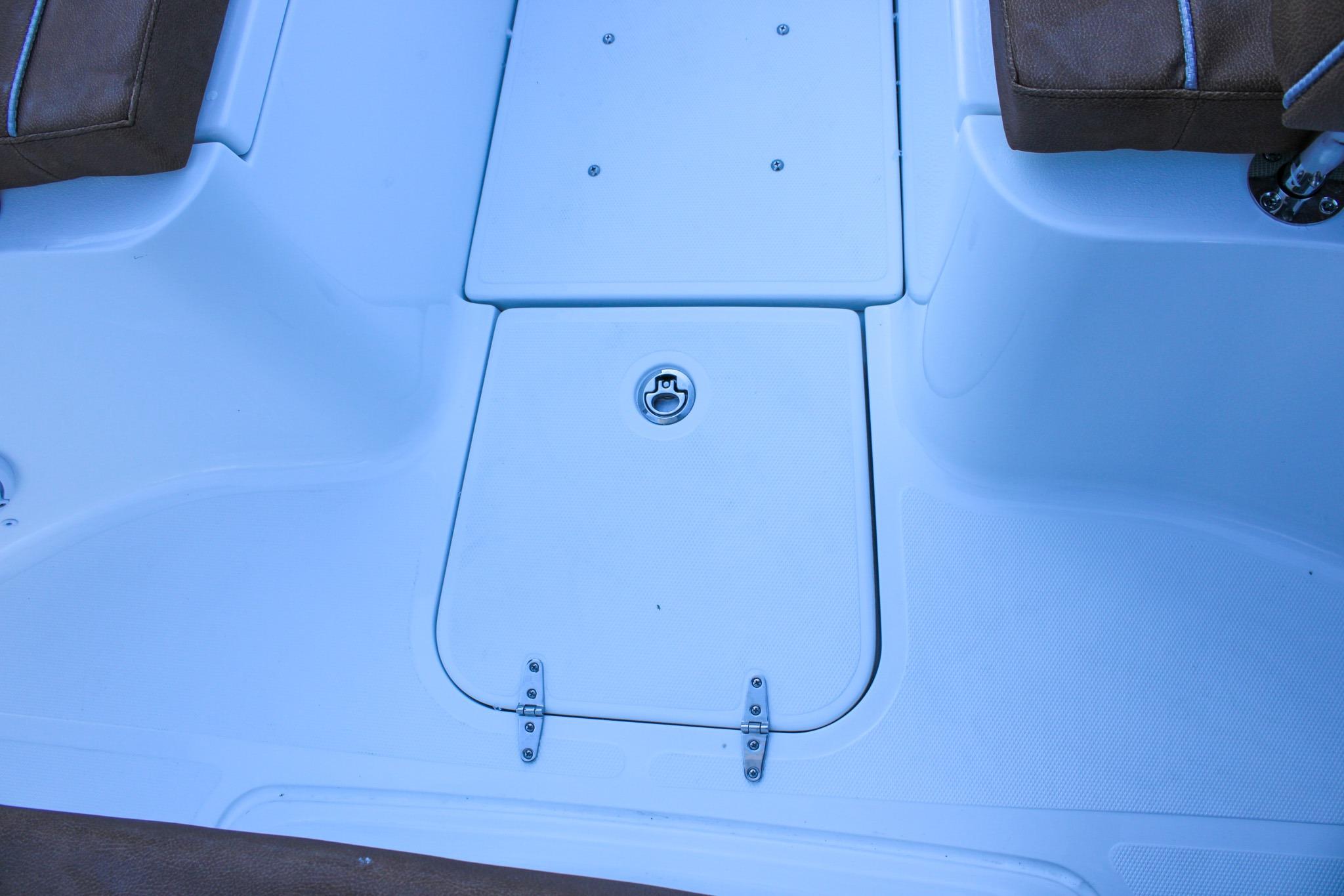 2026 Sea Hunt Gamefish 25 boat deck with storage compartment and brown seating.