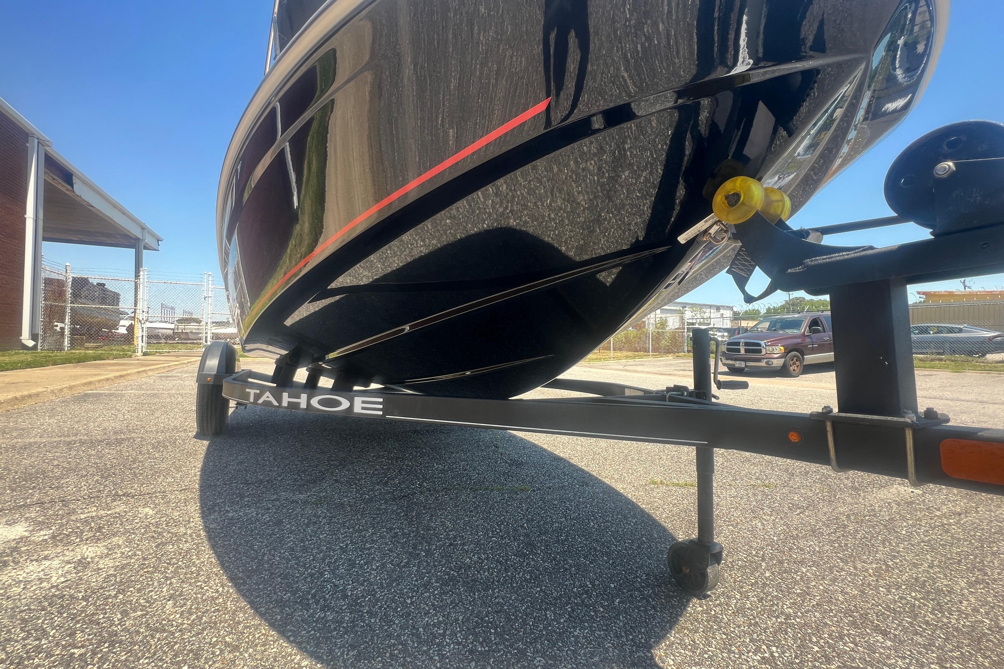 2023 Tahoe T16 boat on trailer in parking lot, sunny day.