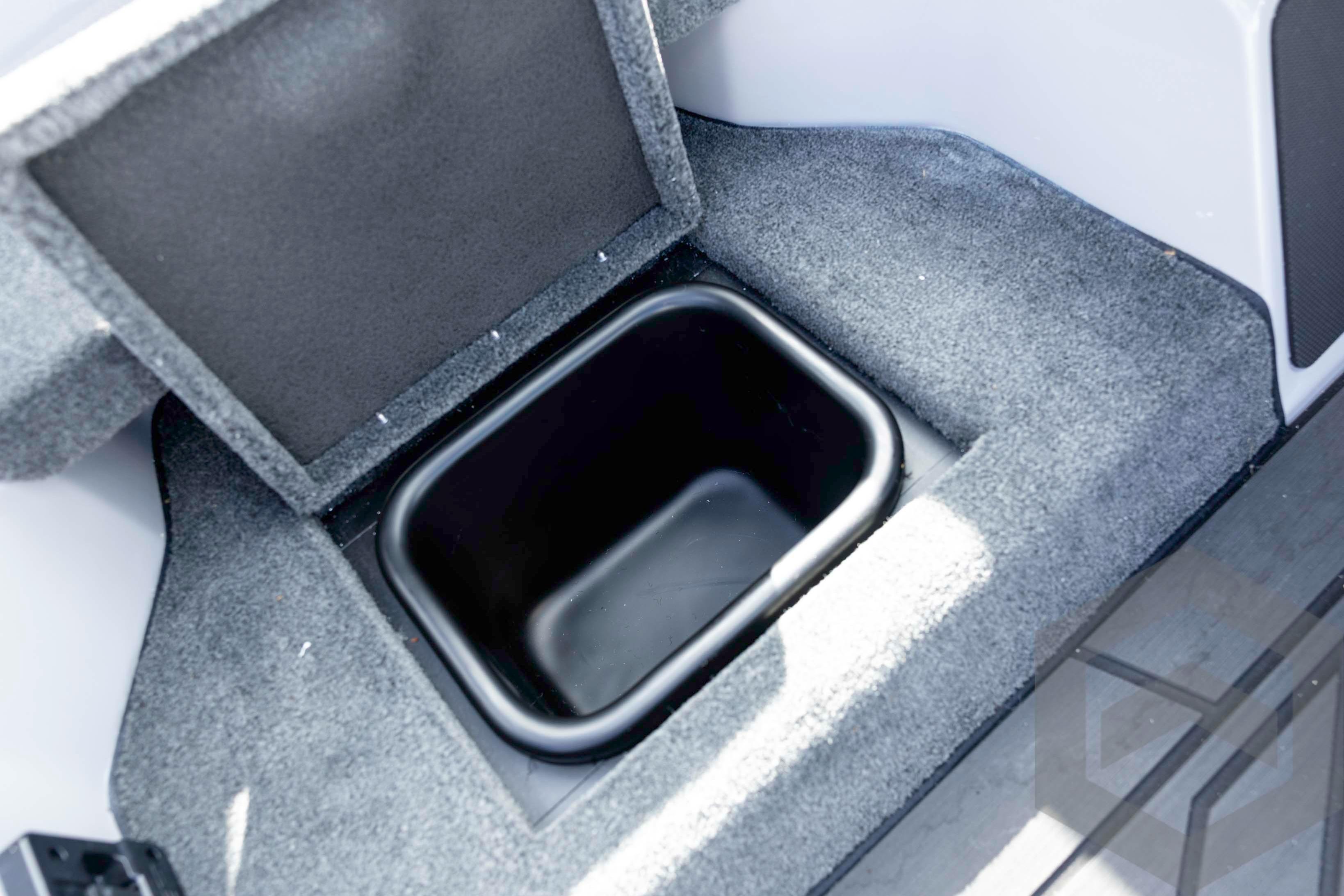 Storage compartment in 2026 Skeeter FXR20 FLEX boat, featuring carpeted interior.