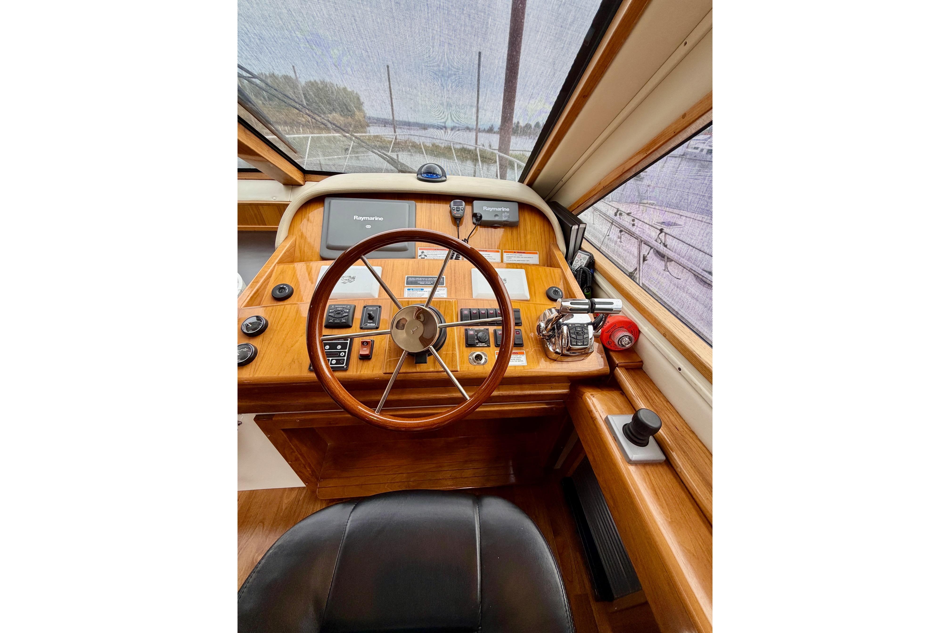 2009 Navigator California 50 Veneti yacht helm with wooden steering wheel and navigation controls.