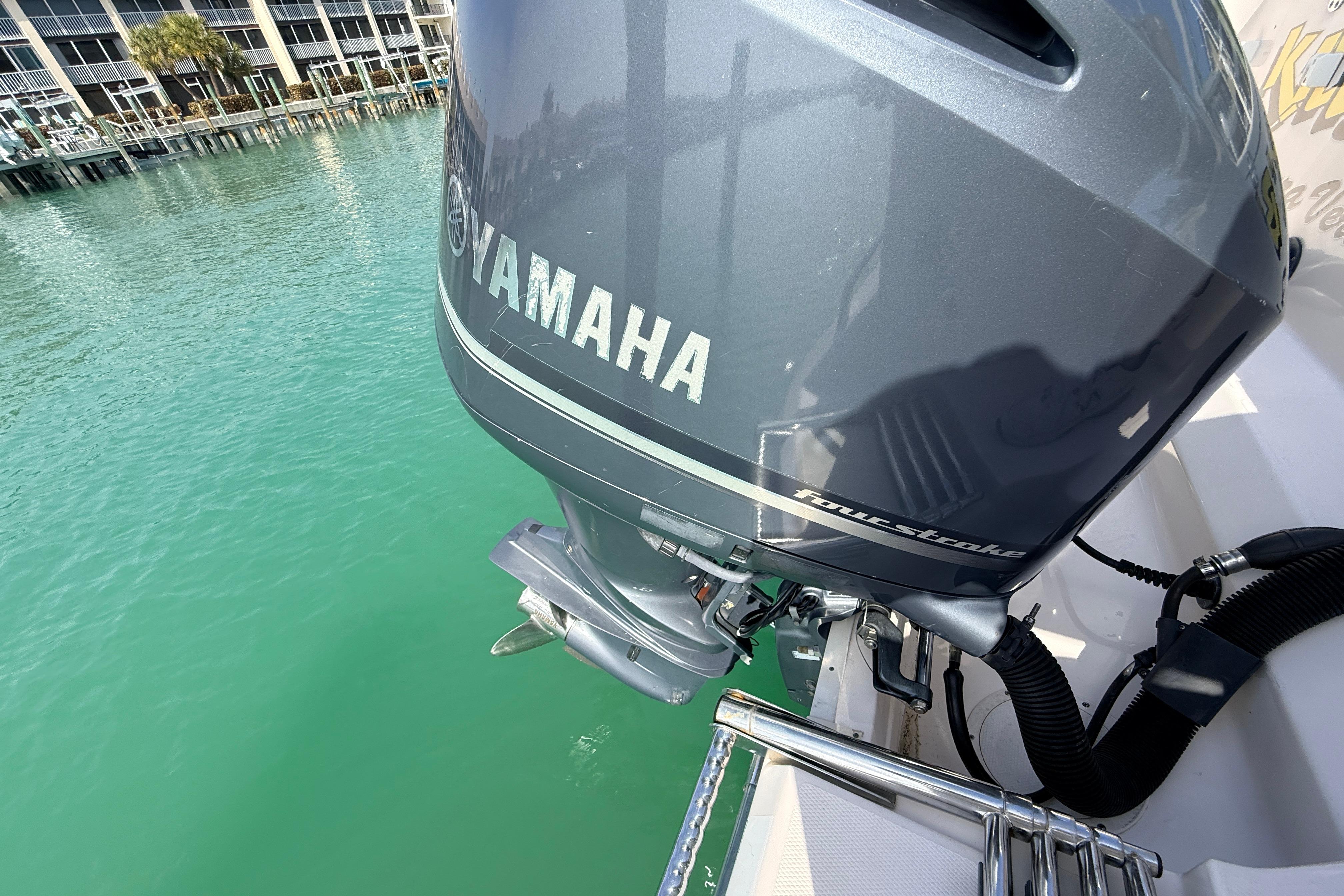 Yamaha outboard motor on 2013 Grady-White Canyon 306 boat, docked in clear water.