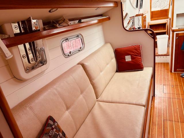 Interior of 2006 Robert Perry Far Harbour 39 yacht with beige seating and wooden accents.
