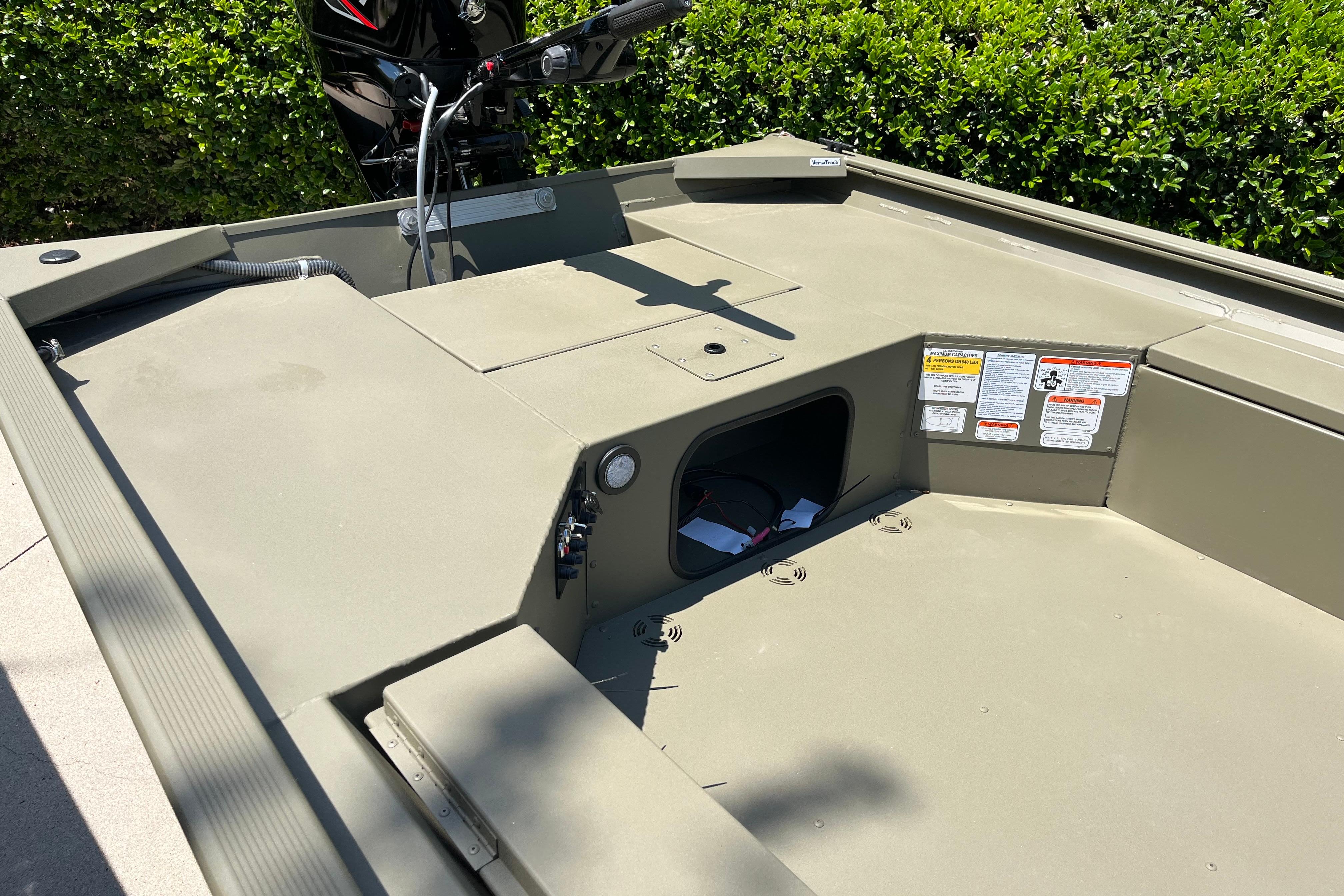 2026 Tracker Grizzly 1654 T Sportsman boat interior with storage compartment and motor.