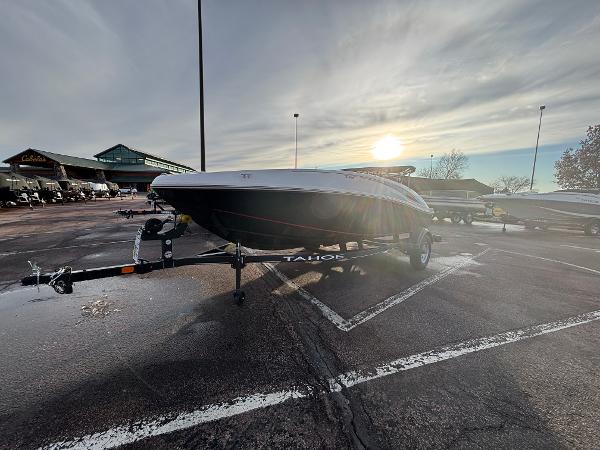 2023 Tahoe T16 boat on trailer in parking lot at sunset.