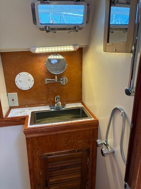 Interior view of a boat bathroom with sink and shower.