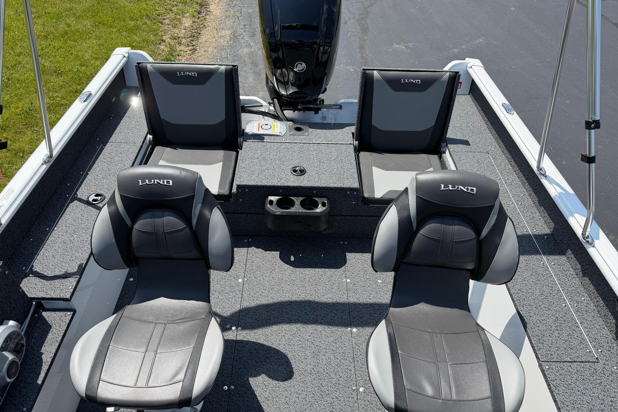 2027 Lund 1675 Adventure Sport boat interior with four seats and a motor.